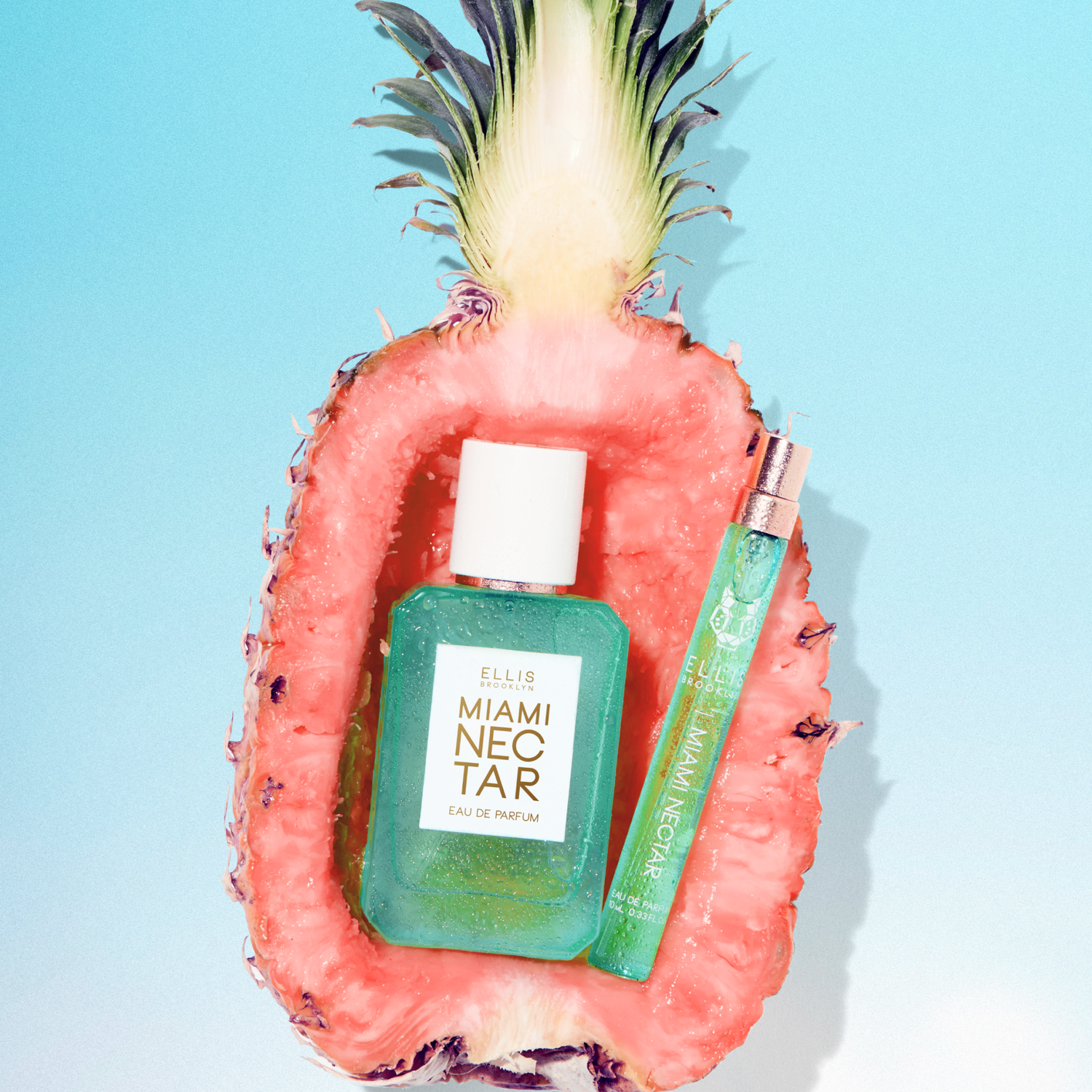 MIAMI NECTAR Eau de Parfum 50ml and MIAMI NECTAR Eau de Parfum 10ml site inside half a pink pineapple on blue background | english_image