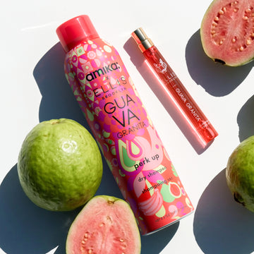Amika x Ellis Brooklyn GUAVA GRANITA Perk Up Dry Shampoo and GUAVA GRANITA Eau de Parfum 10ml next to sliced and whole guavas on white background