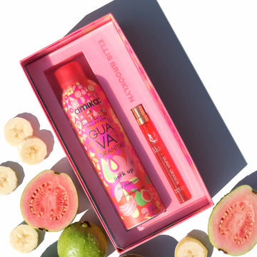 Amika x Ellis Brooklyn GUAVA GRANITA Perk Up Dry Shampoo and GUAVA GRANITA Eau de Parfum 10ml gift set next to whole and sliced guavas and slices of banana on white background