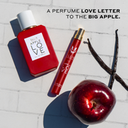 Apple Love 50ml Eau De Parfum, Apple Love 10ml Eau De Parfum Travel Spray, red apple, and vanilla beans on white tile with black text that reads 