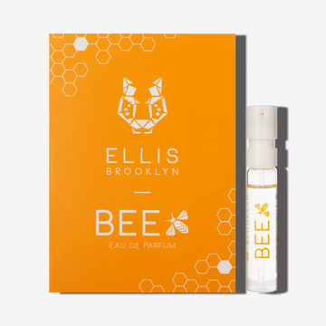 Bee 1.5ml Eau De Parfum Vial next to orange Bee Eau De Parfum vial holder card. | english_image