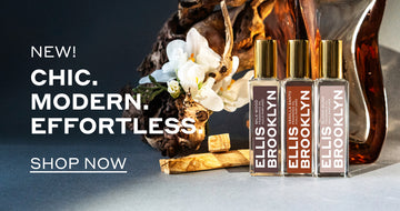 Milk Wood Fragrance Oil 15ml, Vanilla Santo Fragrance Oil 15ml, and Blond Musk Fragrance Oil 15ml in front of sandal wood, block of amber, and piece of wood with white flowers, on grey background, with white text that reads "New! Chic. Modern. Effortless. Shop Now"