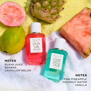 Half guava, whole guava, whole pineapple, and slice of pink pineapple on yellow and white striped beach towel above Guava Granita 7.5ml Eau De Parfum Mini Dabber, black next that reads 