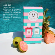 Beach Club Mini Fragrance Gift Set box on white table with whole guava, half guava, whole pineapple, and slice of pink pineapple with pool in background, and white text that reads  