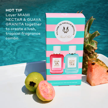 Beach Club Mini Fragrance Gift Set box on white table with whole guava, half guava, whole pineapple, and slice of pink pineapple with pool in background, and white text that reads  