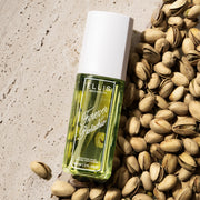 FOREVER PISTACHIO Perfume Mist 90ml on tan marble and pile of pistachios