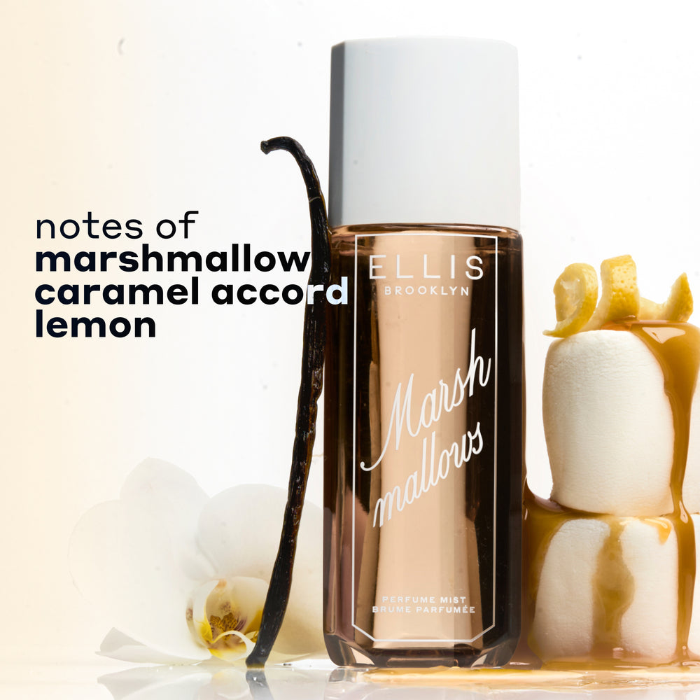 MARSHMALLOWS Perfume Mist 240ml between 2 stacked marshmallows covered in dripping caramel and topped with a lemon peel and a vanilla bean and flower leaning against the bottle on a white background with black text that reads "notes of marshmallow, caramel accord, lemon" | english_image