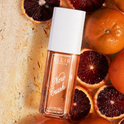 NEW CRUSH Perfume Mist 90ml lays on orange marble, sliced blood oranges, and clementines