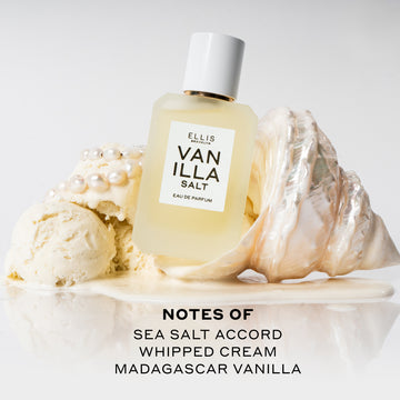 Vanilla Salt 50ml Eau De Parfum resting on white shell in melted vanilla ice cream next to scoops of vanilla ice cream and pearls on white background above black text that reads 