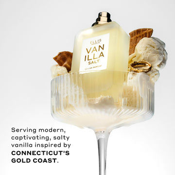 Vanilla Salt 50ml Eau De Parfum without cap in glass with vanilla ice cream, pieces of ice cream cone, and gold ring, on white background, above black text that reads 