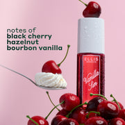 VANILLA SIN Perfume Mist 240ml with a cherry sitting on the cap, sitting on a pile of cherries and a spoon with a cherry on a pile of whipped cream with black text that reads 