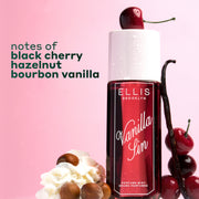 VANILLA SIN Perfume Mist 240ml topped with a cherry and between 4 stacked cherries, a vanilla bean leaning against the bottle and a pile of whipped cream with 4 hazelnuts on a pink and white ombré background with black text that reads 