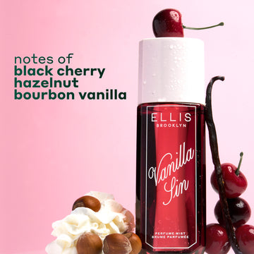 VANILLA SIN Perfume Mist 240ml topped with a cherry and between 4 stacked cherries, a vanilla bean leaning against the bottle and a pile of whipped cream with 4 hazelnuts on a pink and white ombré background with black text that reads 