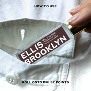 Model wearing white button-down shirt placing Milk Wood Fragrance Oil 15ml into shirt pocket between black text that reads 