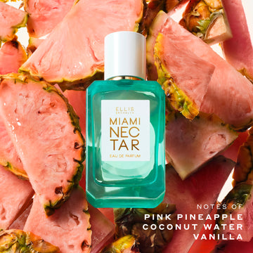 MIAMI NECTAR 50mL Eau de Parfum bottle, surrounded by sliced pink pineapples on a white background with text that reads 