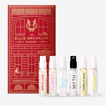 Apple Love 1.5ml Eau De Parfum Vial, Florist 1.5ml Eau De Parfum Vial, Salt 1.5ml Eau De Parfum Vial, Myth 1.5ml Eau De Parfum Vial, Vanilla Milk 1.5ml Eau De Parfum Vial and Sweet 1.5ml Eau De Parfum Vial in front of red An Ellis Brooklyn Mystery Fragrance Discovery Set box. | english_image