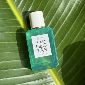 MIAMI NECTAR Eau de Parfum 50ml lays on green, tropical leaf
