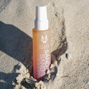 Sand Hair and Body Fragrance Mist 50ml pressed into sand.