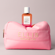 Pink Cosmetic Bag with gold embroidery that reads 