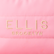 Close up of Pink Cosmetic Bag with gold embroidery that reads 