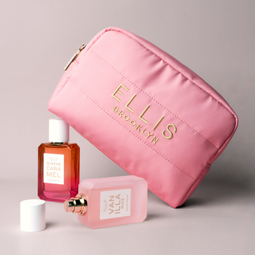 Pink Cosmetic Bag with gold embroidery that reads 
