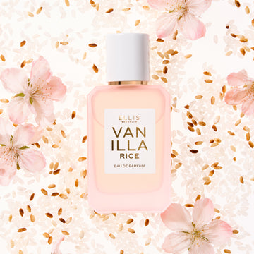VANILLA RICE Eau de Parfum 50ml lays on white rice, toasted rice, and pink sakura blossoms all on white background