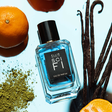 Sci Fi 50ml Eau De Parfum on mirrored background with vanilla beans, oranges, and green tea powder.