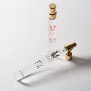 Myth 10ml Eau De Parfum Travel Spray with cap removed next to Rrose 10ml Eau De Parfum Travel Spray on white background.