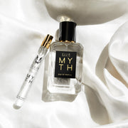 Myth 50ml Eau De Parfum next to Myth 10ml Eau De Parfum Travel Spray on white satin sheet.
