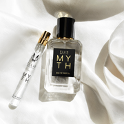 Myth 50ml Eau De Parfum next to Myth 10ml Eau De Parfum Travel Spray on white satin sheet.