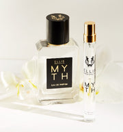 Myth 50ml Eau De Parfum and Myth 10ml Eau De Parfum Travel Spray in front of white flowers on white background.